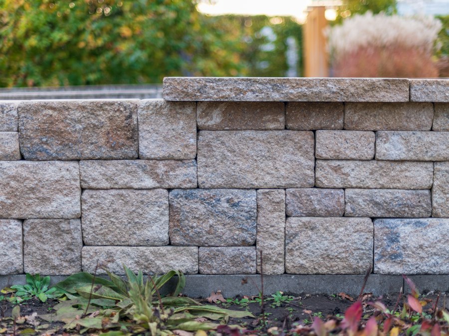 A segmental block retaining wall with planted beds at its base